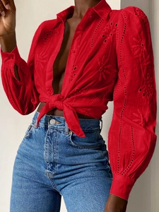 Detail of red hollow-out embroidery long sleeve cardigan with front tie closure
