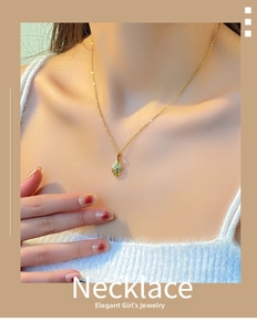 Detailed view of golden leaf pendant featuring realistic vein textures on a delicate chain