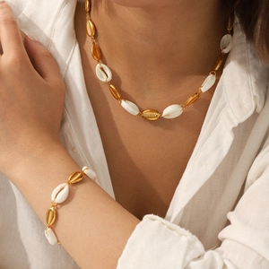 Golden shell necklace and bracelet set on model with stainless steel chain jewelry