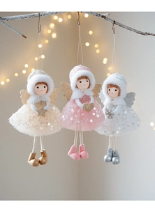 Three plush angel ornaments with mesh skirts and wings hanging on a branch