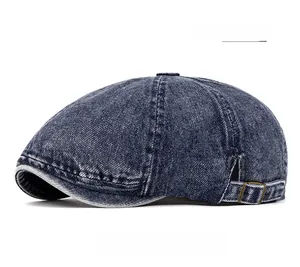 Close-up of vintage washed denim beret with adjustable metal buckle and stitching