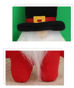 Détail macro du gnome de Noël en peluche avec chapeau en feutre rouge et barbe blanche
