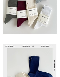 Detail view of multi-color cotton business socks with branded paper bands and knit texture