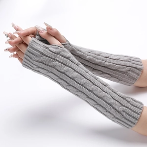 Detailed knit texture of long grey cable-knit arm warmers with fingerless design
