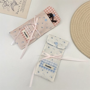 Detailed view of floral cotton glasses pouches with lace trim and ribbon bow accents
