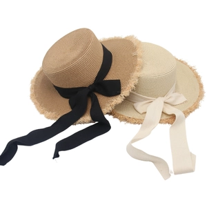 French style wide brim straw hats with elegant black and beige bow ribbons and frayed edges