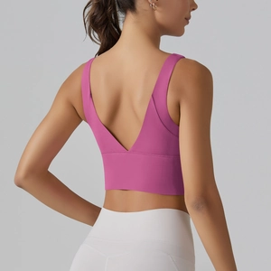 Detail view of fuchsia V-back sports bra with high-elastic fabric for fitness and yoga