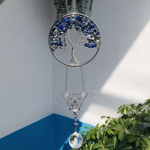 Macro shot of silver Tree of Life hanging decor with blue stone and crystal ball prism