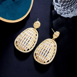 Detailed view of hollow gold-plated teardrop earrings with pavé cubic zirconia inlay