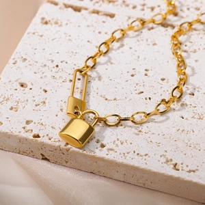 Detail of 18k gold plated double lock pendant necklace with high polished finish