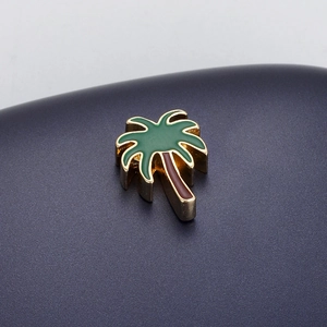 Detailed macro of gold-plated coconut tree enamel pendant for DIY jewelry making
