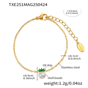 Detail of gold stainless steel crown bracelet with white shell pearl and green oil drip