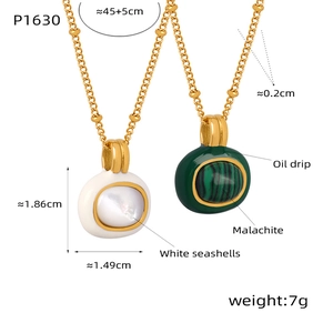 Detailed view of gold plated necklace with white shell and green malachite stone pendants