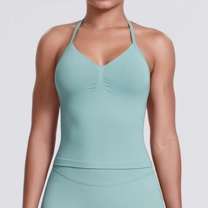 Detail of mint green seamless yoga top featuring V-neckline and ribbed knit texture