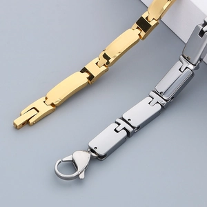 Detailed view of polished steel links and lobster clasp in gold and silver finish