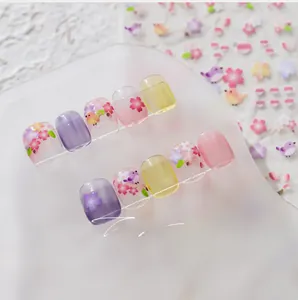 Detail of floral press-on nails featuring spring cherry blossom and bird patterns