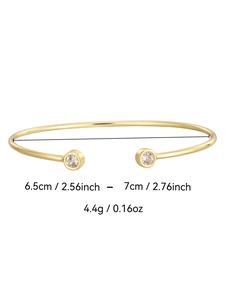 Detailed view of gold open bangle with zircon gems showing 6.5-7cm size and 4.4g weight