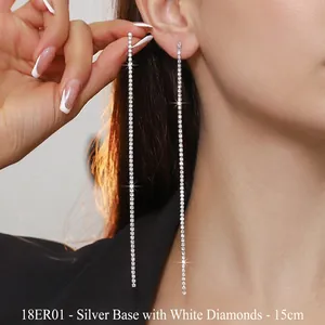 Close-up of 15cm long silver tassel earrings with sparkling rhinestones on model