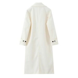 Detail view of the back seams and buttoned cuffs on a long cream wool coat for women