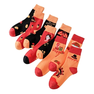 Five-pack of festive Thanksgiving crew socks with pumpkin and turkey prints on white background