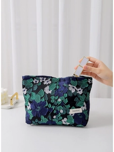 Floral jacquard toiletry bag with vintage flower pattern being filled with lipstick