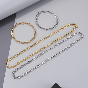 Flat lay of gold and silver hollow cross chain necklaces and matching bracelets set