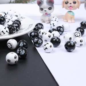 Detailed close-up of pet-themed wooden beads with dog paw, bone patterns and PET text