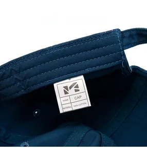 Detailed close-up of 100% cotton baseball cap interior stitching and care label