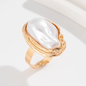 Elegant gold-tone ring featuring a large baroque pearl and irregular metal texture