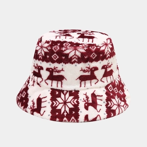 Detailed view of the thick plush fabric and festive reindeer jacquard pattern on the hat