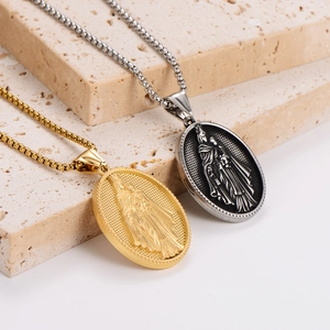 Gold and silver stainless steel Virgin Mary oval pendant necklaces on textured stones