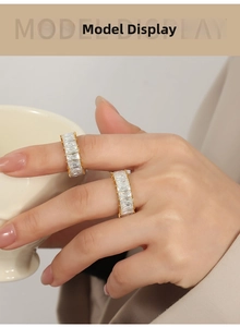 Close-up of elegant gold-plated rings set with rectangular cubic zirconia on a model