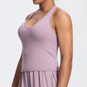 Close-up of the mauve sports bra featuring a U-neckline and racerback fit on the model