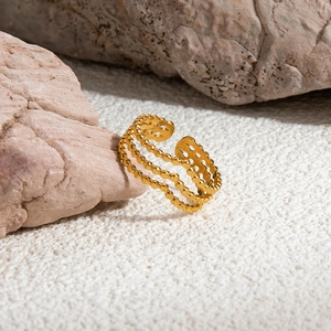 Minimalist 18K gold plated stainless steel V-shaped layered ring on textured stones