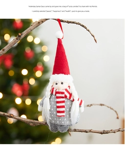 Close-up of a plush Christmas gnome ornament with a red pointed hat hanging on a tree