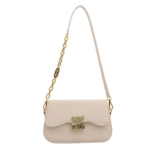Chic beige saddle bag with wavy flap design and gold metal chain strap on white background