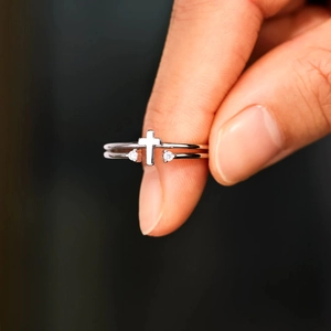Close-up of a double-layered 925 sterling silver ring with a cross and zircon stones