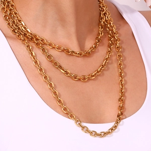 Detail of triple-layer 18K gold-plated stainless steel chain necklace on model