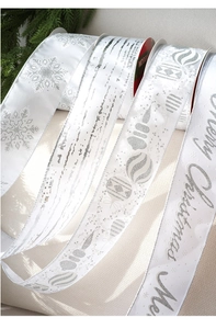 Detail of white and silver Merry Christmas velvet ribbons with snowflake patterns