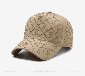 Détail d'une casquette kaki ornée de lettres en strass dorés et motifs en losanges
