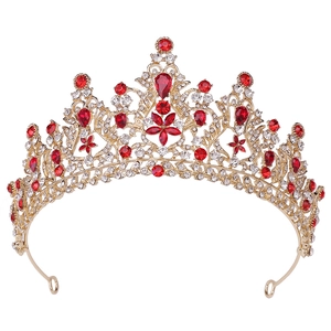 Detail of luxury bridal crown with brilliant red rhinestones and gold metal finish