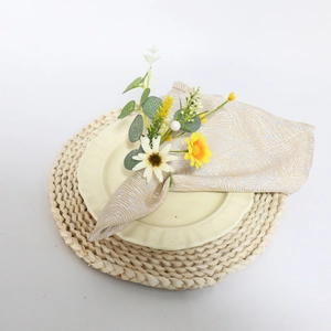 Eucalyptus and daisy floral napkin ring with white pearl berry on a golden textured napkin