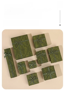 Set of dark green vintage jewelry boxes with paisley patterns and satin bow details
