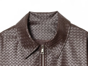 Close-up of dark brown woven leather jacket collar with detailed metallic zipper