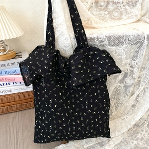 Detail of floral tote bag with romantic ruffle edge and yellow flower pattern