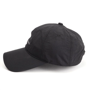 Detail view of lightweight black quick-dry baseball cap with side embroidery and curved brim