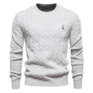 Detailed view of light grey knit sweater featuring cable patterns and giraffe embroidery