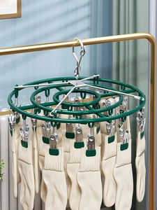 Detail of green drying rack showing sturdy hooks and clips holding multiple cotton socks