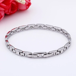 Close-up of silver titanium steel magnetic bracelet with polished finish and inlay details