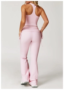Detail view of pink yoga set showing racerback top and flared leggings with side drawstrings